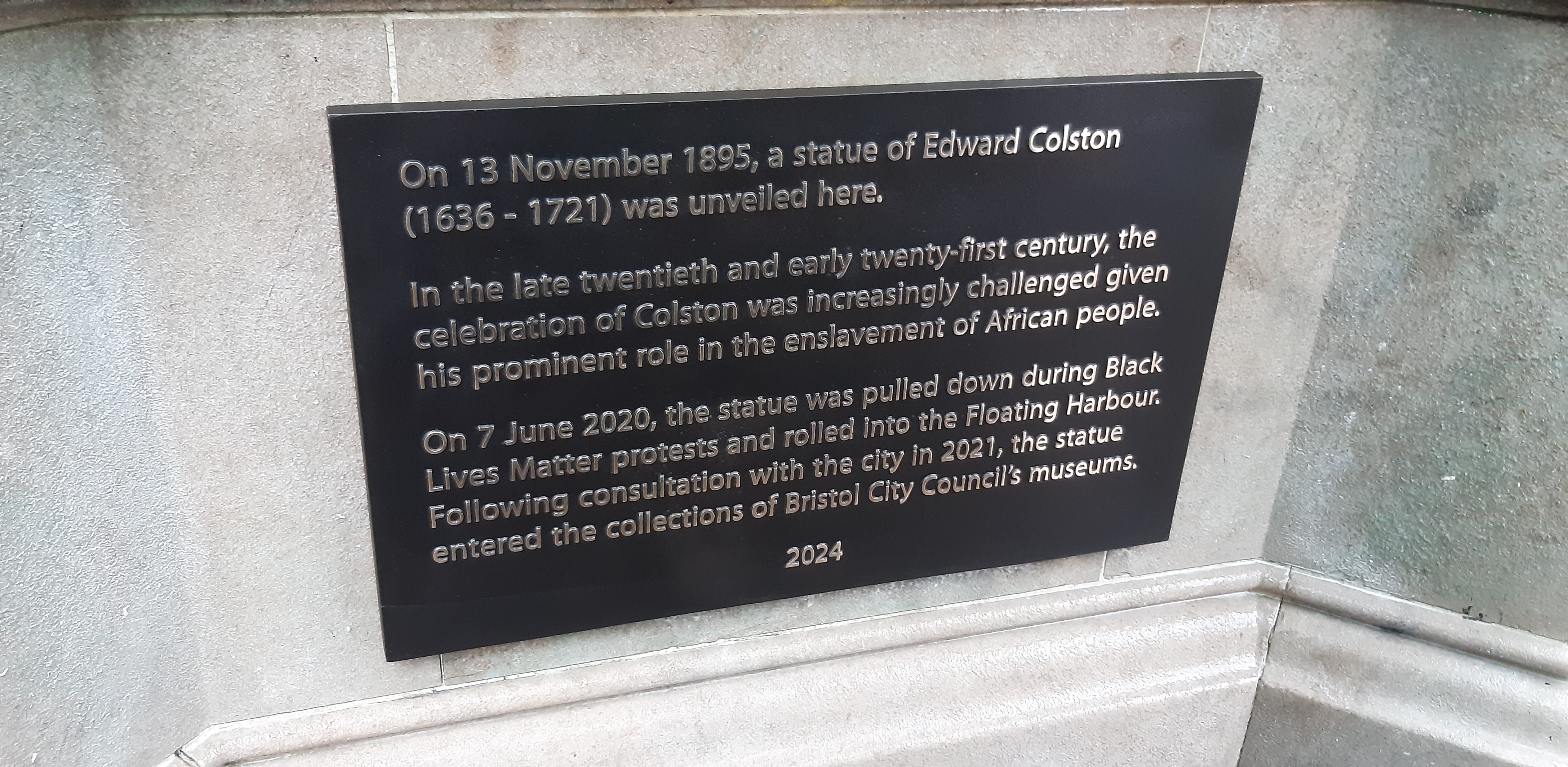 Empty plinth and new plaque at the former Colston statue site, Bristol